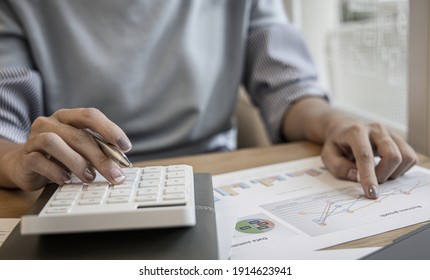 Financial businesswoman calculating corporate income tax data And analyzing charts of financial stocks that are in good condition with growth and progress, Investment in finance and accounting.