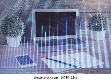Financial chart drawing and table with computer on background. Multi exposure. Concept of international markets.