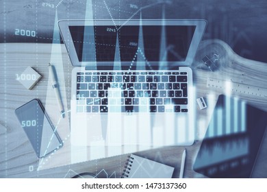 Financial chart drawing and table with computer on background. Double exposure. Concept of international markets.