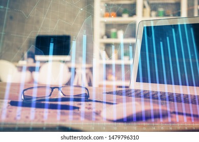 Financial chart drawing and table with computer on background. Multi exposure. Concept of international markets.