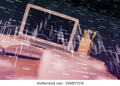 Financial chart drawing and table with computer on background. Double exposure. Concept of international markets.