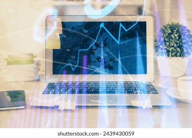 Financial chart drawing and table with computer on background. Double exposure. Concept of international markets.
