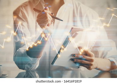 Financial chart drawn over hands taking notes background. Concept of research. Multi exposure - Shutterstock ID 1641691819
