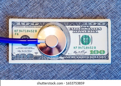 Financial Checkup: Stethoscope On Pile Of U.S. Hundred Dollar Bill On Grey Background. Financial Wellness. Toned