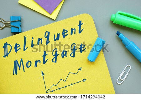 Financial concept about Delinquent Mortgage with inscription on the piece of paper.