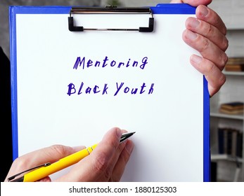  Financial Concept About Mentoring Black Youth With Sign On The Piece Of Paper.
