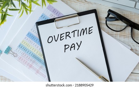 Financial Concept About OVERTIME PAY With Sign On The Sheet.