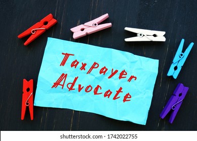 Financial Concept About Taxpayer Advocate With Sign On The Sheet.