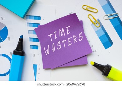  Financial concept about TIME WASTERS with sign on the piece of paper. 