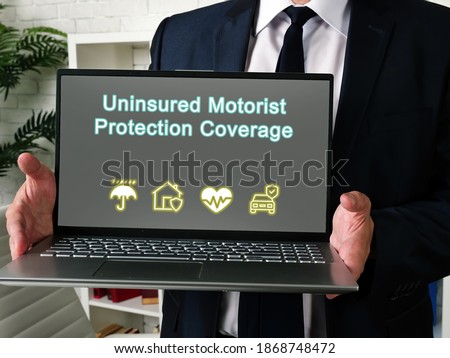  Financial concept about Uninsured Motorist Protection Coverage with sign on the sheet.
