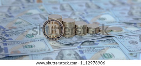 Financial concept image. Histogram of coins and bitcoin against the background of dollars.