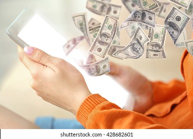 Financial Concept. Make Money On The Internet. Female Hand Holding PC Tablet On Home Interior Background