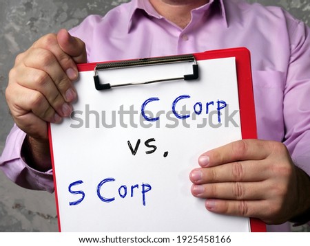  Financial concept meaning C Corp vs. S Corp with inscription on the piece of paper.
