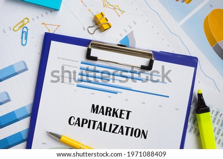 Financial concept meaning Market Capitalization with phrase on the piece of paper. 
