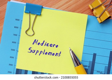  Financial concept meaning Medicare Supplement with inscription on the piece of paper. - Shutterstock ID 2100855055