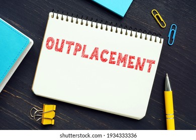 Financial concept meaning OUTPLACEMENT with sign on the sheet. OutplacementÂ is any service that assists a departing employee with obtaining a new job or transitioning to a new career