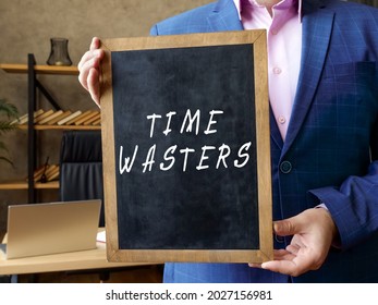 Financial concept meaning TIME WASTERS with inscription on the board 