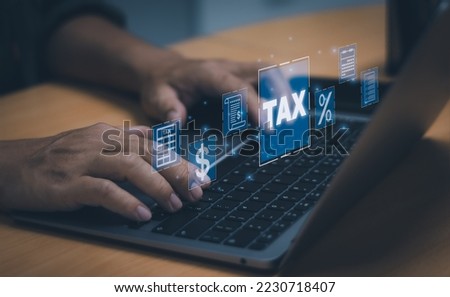 Financial concept or online taxes filing, man typing with laptop computer show income and expenses to fill out a personal income tax payment form.