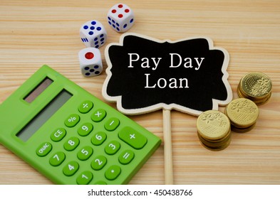Financial concept- Pay Day loan  (Calculator,coins,dice on wooden background)