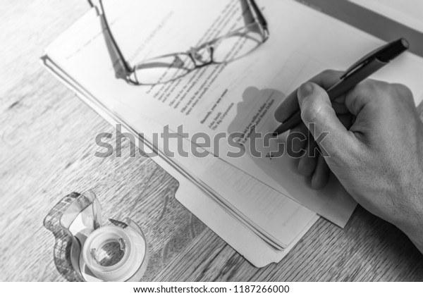Financial contract for business\
purchase agreement.  Paper documents with pen and hand\
signing.