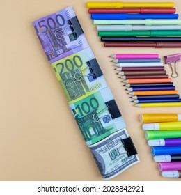 Financial, creativity and art background still life with euro and dollar banknotes in assorted denominations and colorful arrangements of marker pens and pencil crayons