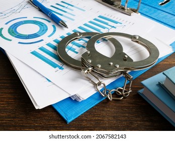 Financial Crime Concept. Handcuffs And Folder With Audit Report.