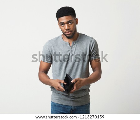 Financial crisis and bankruptcy. Unhappy sad man showing empty wallet, white studio background