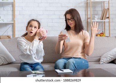 Financial Crisis During Coronavirus Pandemic Concept. Teen Girl With Empty Piggy Bank And Young Mother With No Money To Pay Bills At Home, Having Problems With Family Budget