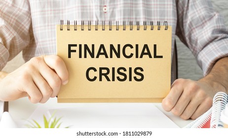 Financial Crisis Word Written On A Piece Of Paper.