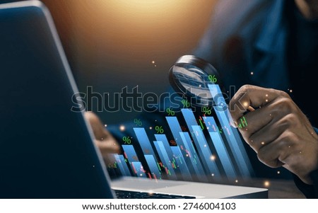 Financial data analysis concept with magnifying glass over stock market chart. Investment research, performance review, risk assessment and business intelligence analytics dashboard.
