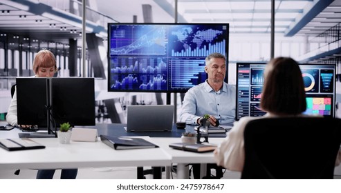 Financial Data Analysts Using Performance Dashboard On Screens In Office