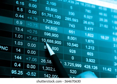 Financial data on a monitor. Business statistics and analytics, glowing sheet beznes statistics of exchange trading in the dark.