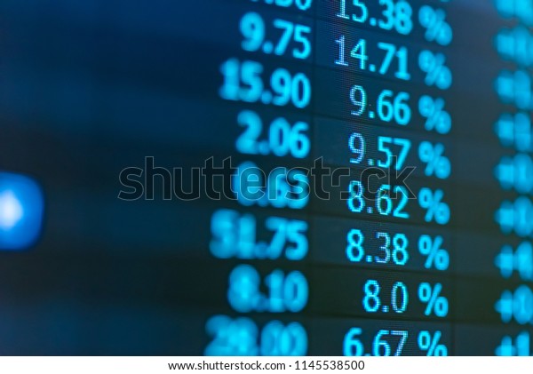 Financial data in term\
of a digital prices on LED display. A number of daily market price\
and quotation of prices chart to represent candle stick tracking in\
Forex trading.