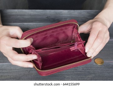 Financial Difficulties Concept, Woman`s Hands Holding An Old Empty Wallet. 