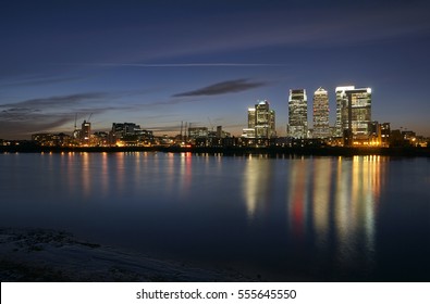 The financial district of Canary Wharf illuminated at night in East London, uk