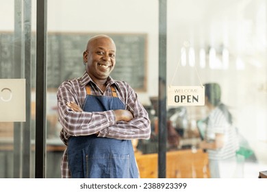 Financial freedom of small business Shot of a cheerful senior man smiling happily holding up an open sign posing at his own cafe in front of the door senior male standing his small business sme. - Powered by Shutterstock