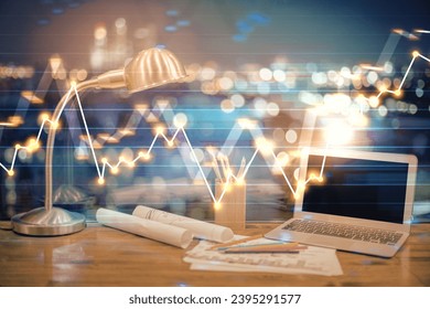 Financial graph colorful drawing and table with computer on background. Double exposure. Concept of international markets. - Shutterstock ID 2395291577