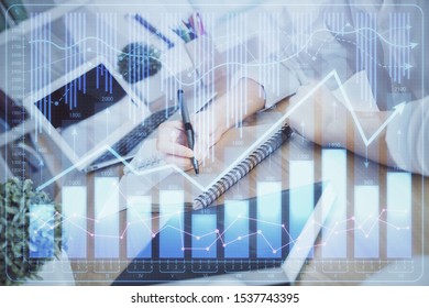 Financial graph displayed on woman's hand taking notes background. Concept of research. Double exposure