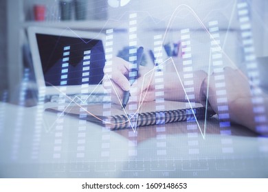 Financial graph displayed on woman's hand taking notes background. Concept of research. Double exposure - Shutterstock ID 1609148653