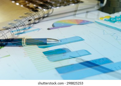 Financial graphs analysis and pen. - Shutterstock ID 298825253