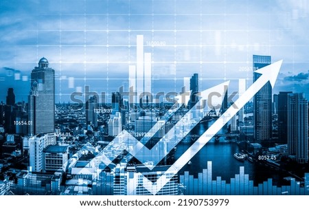 Financial graphs and digital indicators overlap with modernistic urban area, skyscrabber for stock market business concept. Double exposure.