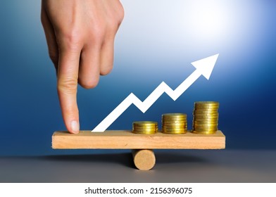 Financial Leverage And Money Balance. Finance And Price. Stacks Of Coins In A Inflation Chart And Red Arrow. Stack Coin On Wooden Table With Handwriting Bar Graph, Dollar Sign Symbol And Point Up.