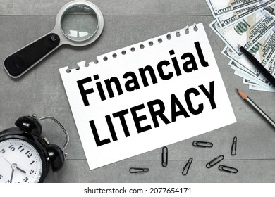 FINANCIAL LITERACY. Black Paw Alarm Clock Money On A Gray Background