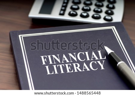 Financial Literacy book with pen and calculator