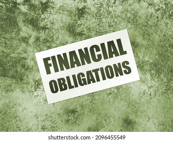 Financial Obligation words on card on wooden table. Business debts concept. - Shutterstock ID 2096455549