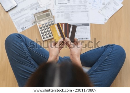 Financial people, owe asian woman, girl sitting on floor at home, hand holding credit card and bills, stressed  by calculate expense, no money to pay, mortgage or loan. Debt, bankruptcy or bankrupt. Stock photo © 