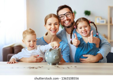 Financial Planning Happy Family Mother Father And Children With Piggy Bank At Home     
