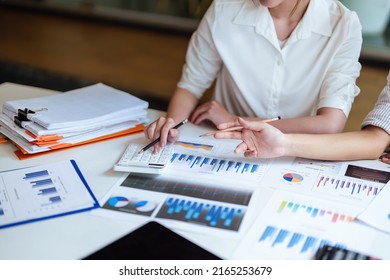 financial, Planning, Marketing and Accounting, Asian young Economist using calculator to calculate investment documents with partners on profit taking to compete with other companies