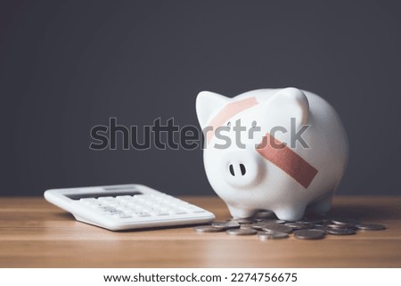 Financial problem, Bankrupt or fail in business concept. White piggy bank with plastic adhesive bandages on wooden desk with dark copy space wall background. Fail, Bankrupt or unsuccessful idea. Stock photo © 