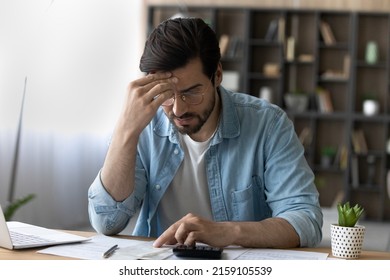 Financial Problem. Concerned Millennial Businessman Calculate Taxes Bills Payments Deal With Debt Bankruptcy Overdue Account. Worried Young Man Accountant Unable To Form Balance Sheet Look For Mistake